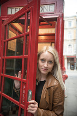 girl coming out of phone box

