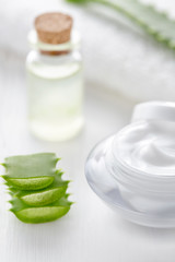 Aloe vera cosmetic cream in product container with glass bottle on white background. Skin face and body care hygiene moisture anti wrinkle natural healthy dermatology medicine therapy treatment.