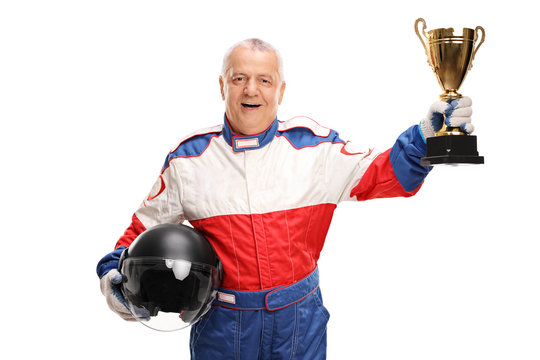 Senior car racing champion holding a trophy