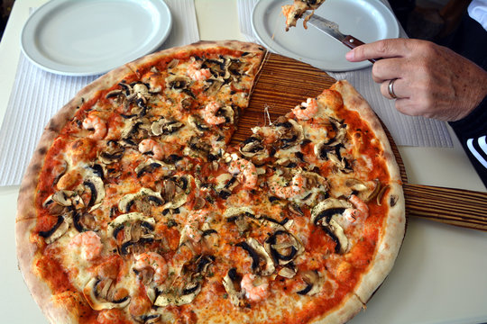 Fresh Italian pizza with cheese, mushroom and  prawns