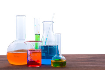 Different laboratory glassware with water and empty with reflection on white background
