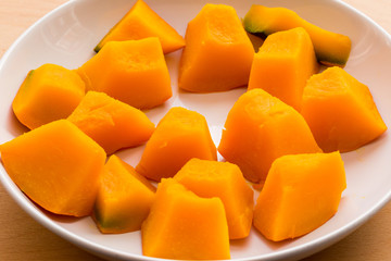 Slices of boiled pumpkin on white dish