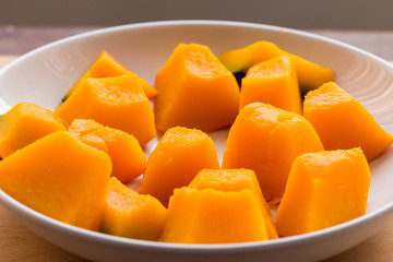 Slices of boiled pumpkin on white dish