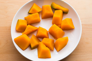 Slices of boiled pumpkin on white dish
