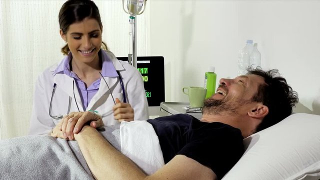 Male patient and female doctor looking camera happy showing thumbs up
