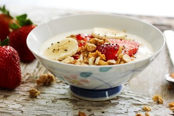 Breakfast yogurt bowl with strawberries, selective focus