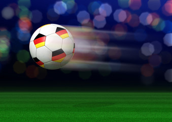 Fototapeta premium Fliegender Fußball mit Deutschlandfahne