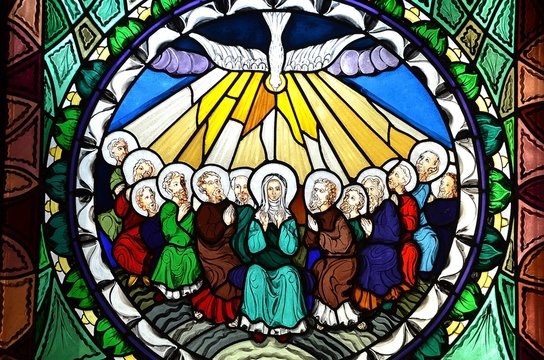 stained glass window depicting Pentecost