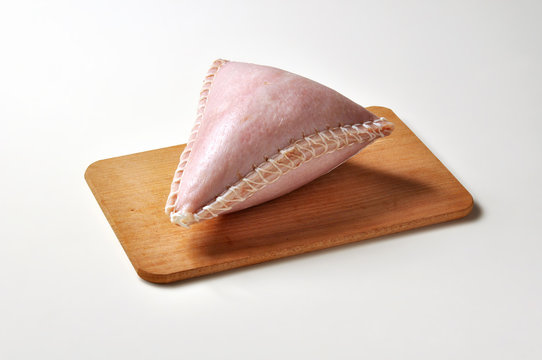 Cappello del prete salame in pork rind on cutting board
