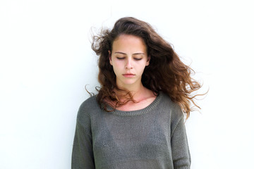 Attractive woman with long brown hair looking down © mimagephotos