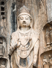 Fototapeta na wymiar Stone buddhist statue in Longmen Grottoes, China