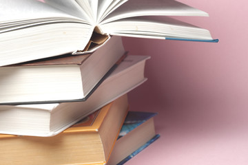 Stack of colorful books, grungy blue background, free copy space. Education essential for self improvement, gaining knowledge and success in our careers, business and personal lives.