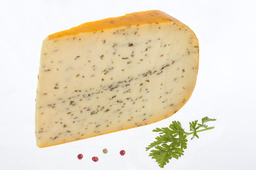 Portion of gouda with cuminon white background