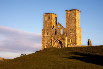 Remains of Reculver church towers bathed in late afternoon sun in winter