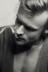  Emotive portrait of young fashionable model smoking  cigarette. Retro style. Close up. Black and white studio shot. 