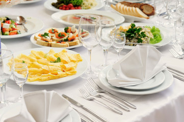 Served table in restaurant with dishes and glasses