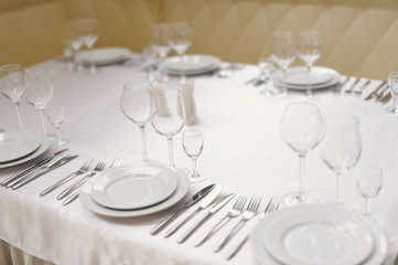 Served table in restaurant with dishes and glasses