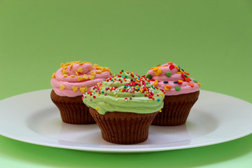 Sweet chocolate cupcake. Close up of chocolate cupcake. Muffins. Fresh delicious homemade cupcakes. Chocolate cupcakes with chocolate frosting on top with sugar sprinkles. Shallow depth of field.