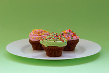 Sweet chocolate cupcake. Close up of chocolate cupcake. Muffins. Fresh delicious homemade cupcakes. Chocolate cupcakes with chocolate frosting on top with sugar sprinkles. Shallow depth of field.