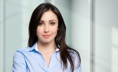 Fototapeta na wymiar Young businesswoman portrait in a modern office