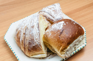Croissant and bread cut into the pot on the wooden table