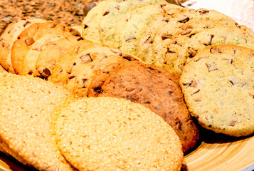 different kinds of homemade cookies on plates close up
