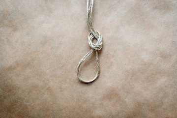 Fototapeta na wymiar concept hangman's knot on kraft paper background