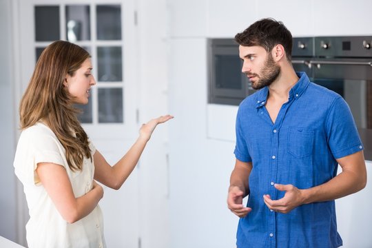 Young couple arguing in kitchen