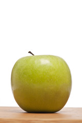 green apple on a wooden plank