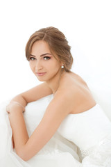 Brides beauty. Young woman in wedding dress indoors