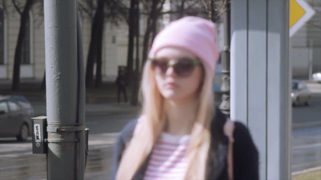 Beautiful young girl is walking on a beautiful sunny streets. Slow motion