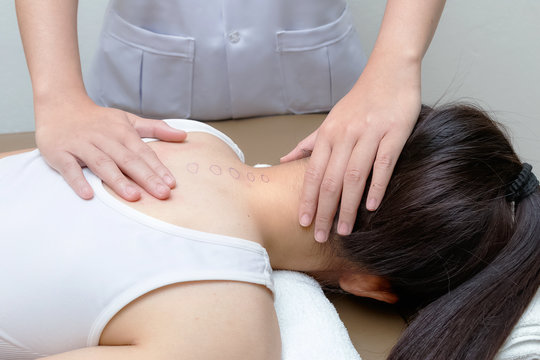 Chiropractor doing adjustment spinal spine on female patient