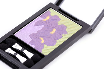 isolated makeup set: box of eye shadows, green and violet color on white