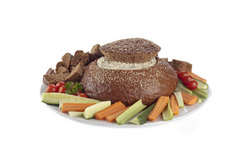 pumpernickel bread filled by spinach dip with vegetables slices