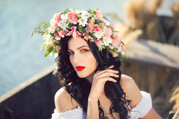 Fashion art photo of a beautiful lady sitting in the boat