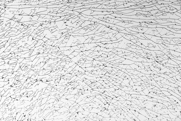 Broken glass with cracks pattern, monochrome photo