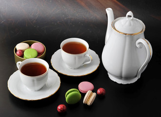 morning tea - two tea mug with tea and macarons