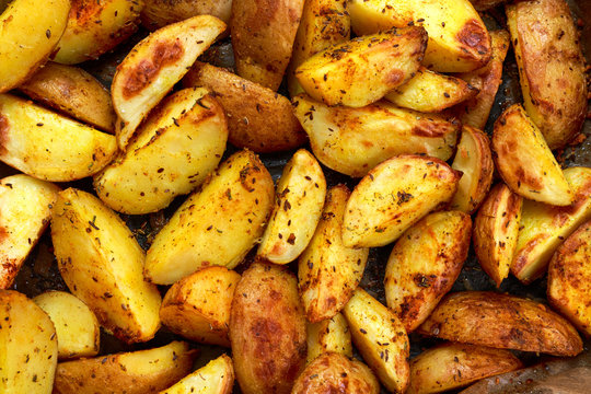 Baked, Roasted potatoes with rosemary and spices. Ready to eat. 