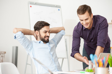 Attractive young men are working in office