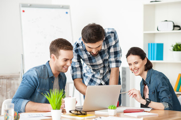 Fototapeta premium Cheerful creative team is working in office