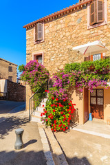 Entrance to typical French house decorated with flowers in Piana village, Corsica island, France