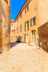 Street with historic houses in Calvi old town, Corsica island, France