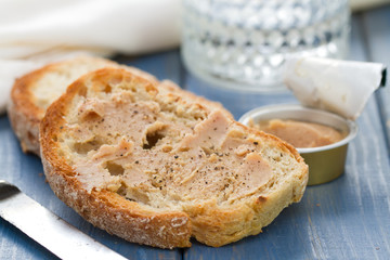 bread with fish pate on blue wooden background