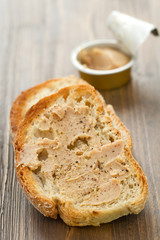 bread with fish pate on brown wooden background