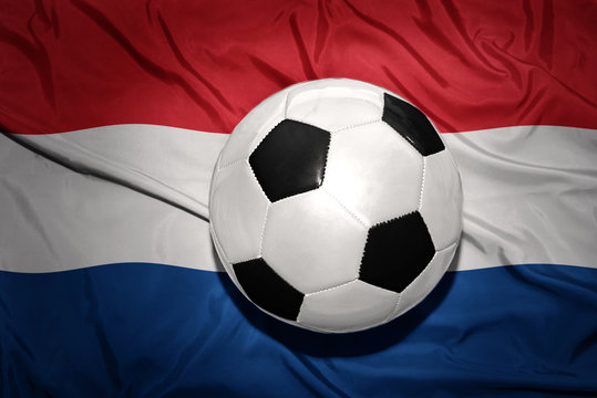 black and white football ball on the national flag of netherlands, dutch, amsterdam,