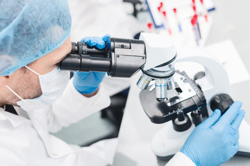 Cheerful male researcher is doing test in lab