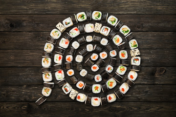 Set of sushi maki and rolls at black rustic wood. © Prostock-studio