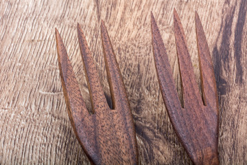 Wooden forks on a wooden background