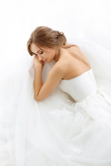 Obraz na płótnie Canvas Brides beauty. Young woman in wedding dress indoors