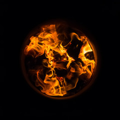 Flames burning in oak barrels for firing its inner side in the cooper's workshop